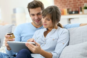 Couple using laptop to give electronically